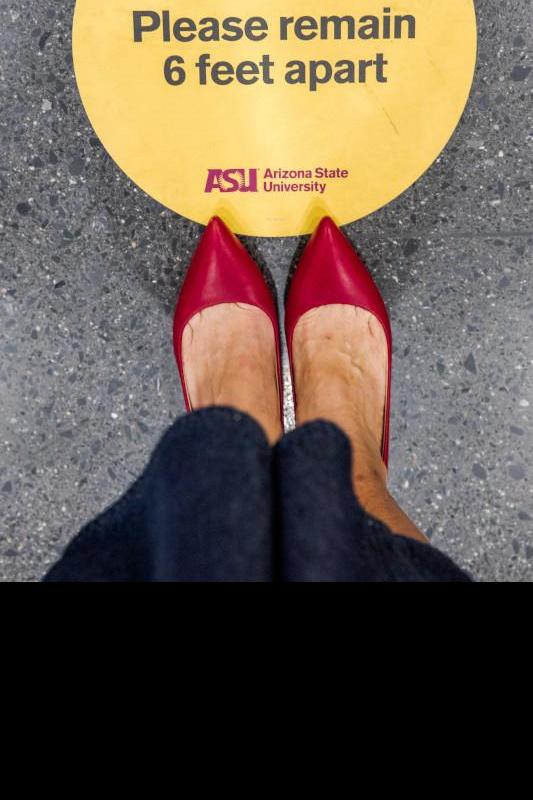 person's feet standing on ASU branded "please remain 6 feet apart sticker"